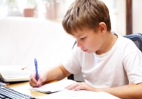 A  child writing at a desk